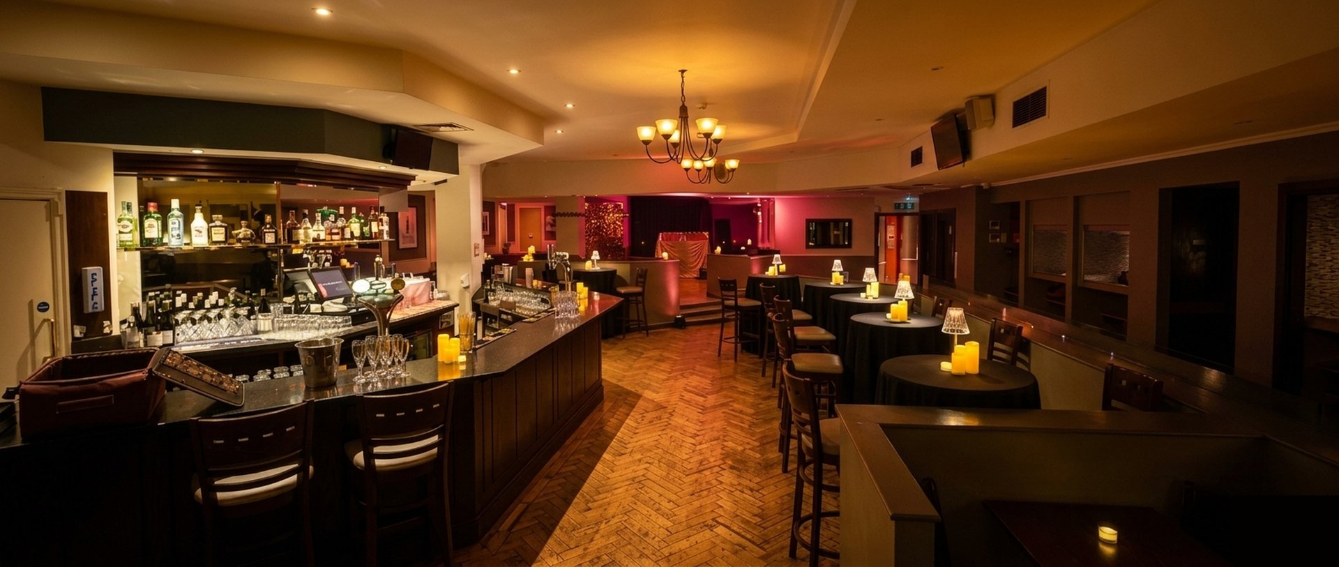 Steam Wine Bar interior, the full venue set for an evening, bar to stage, candlelit and atmospheric